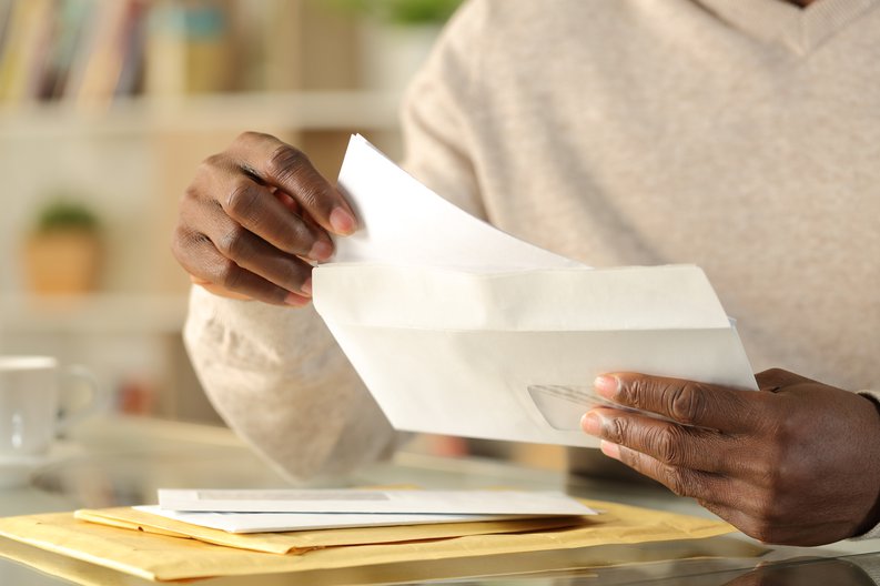 Man Opening Envelope