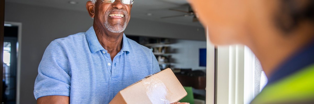 Man accepting package from a delivery driver