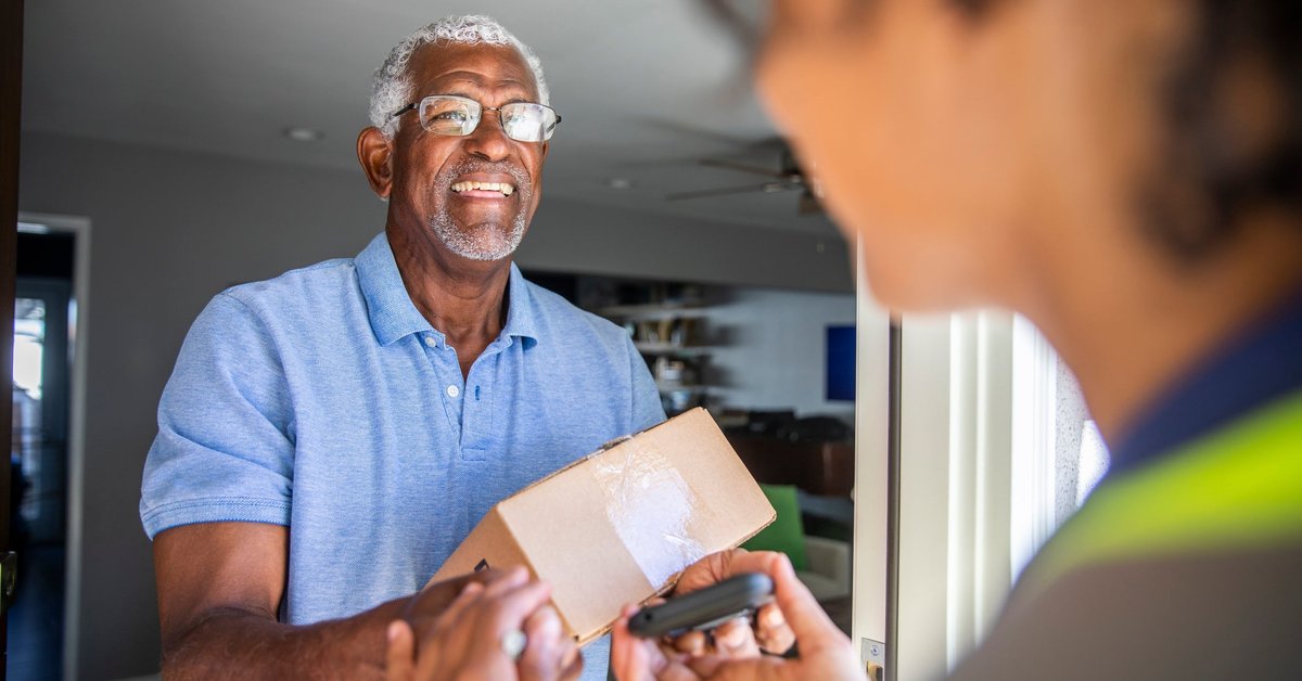 Man accepting package from a delivery driver