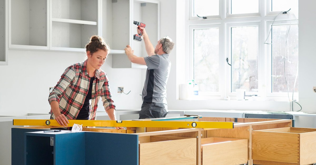 Man and woman working on a kitchen remodel.