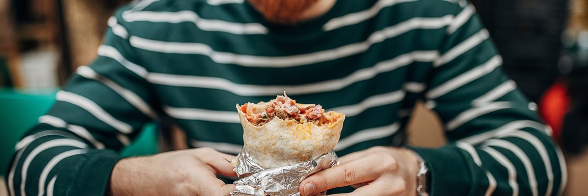 Man enjoying a burrito.
