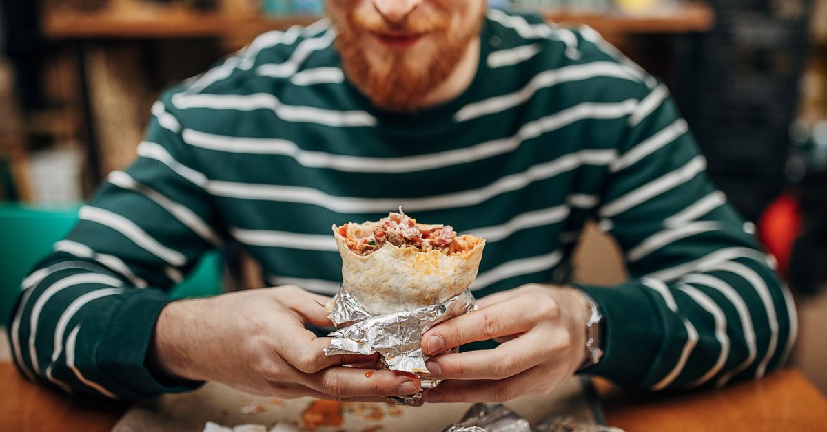 Man enjoying a burrito.