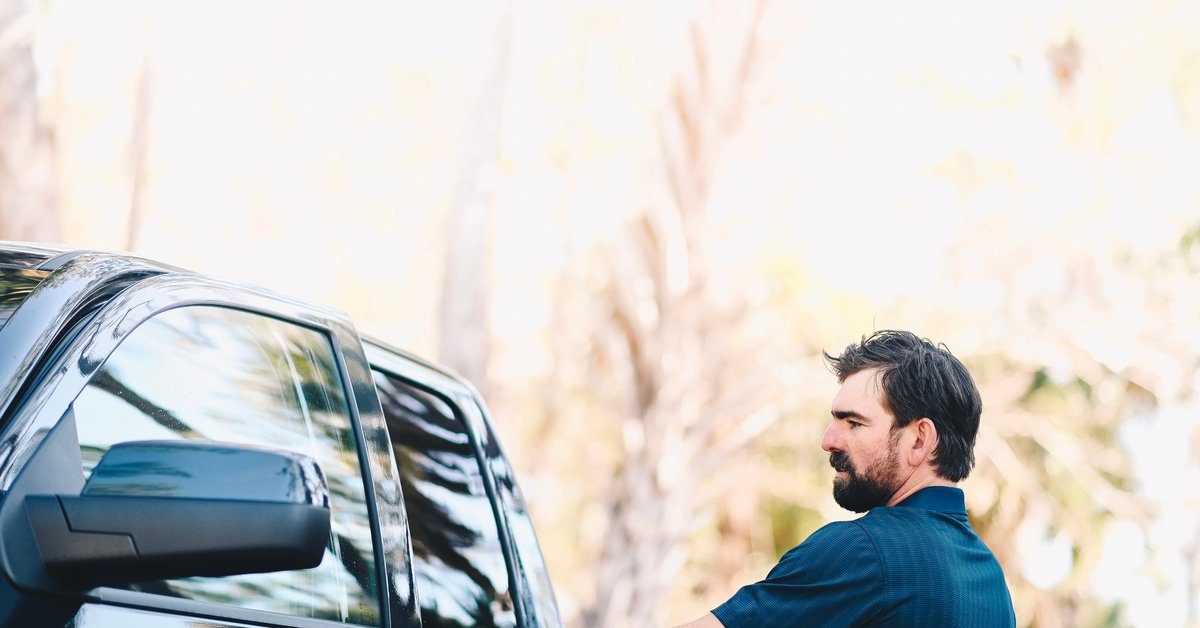 Man getting in to his pickup truck