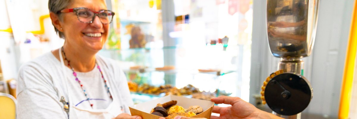 Mature woman selling a box of baked goods