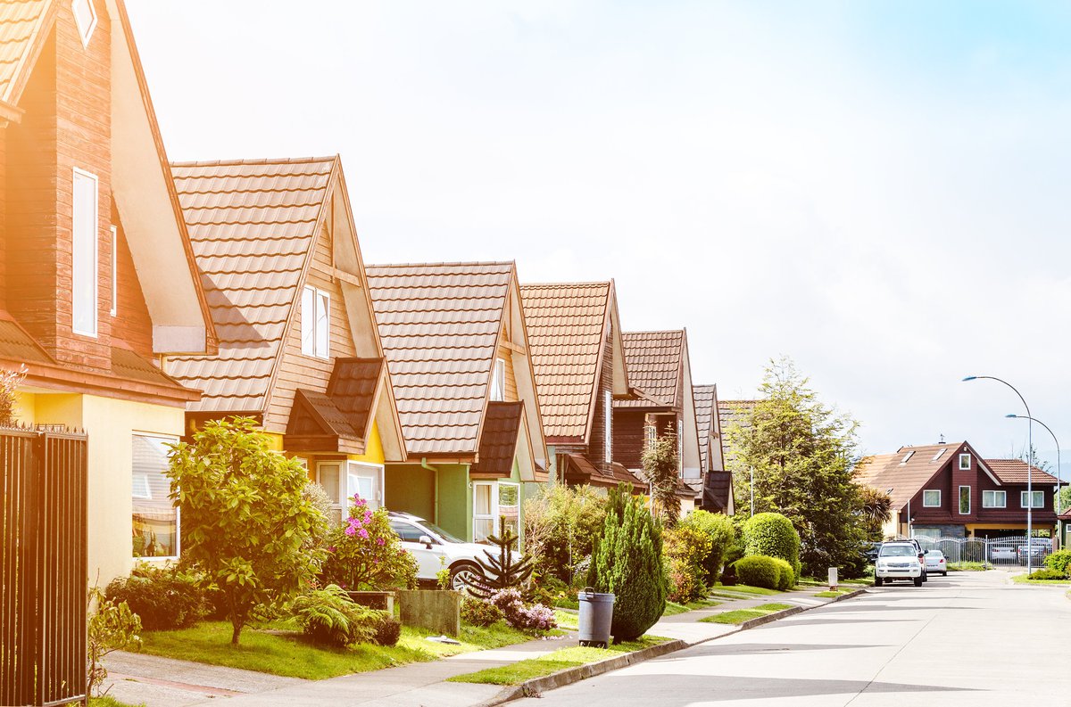 A row of houses in a sunny neighborhood.