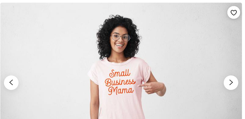 A woman with glasses pointing to her shirt that says “Small Business Mama.”