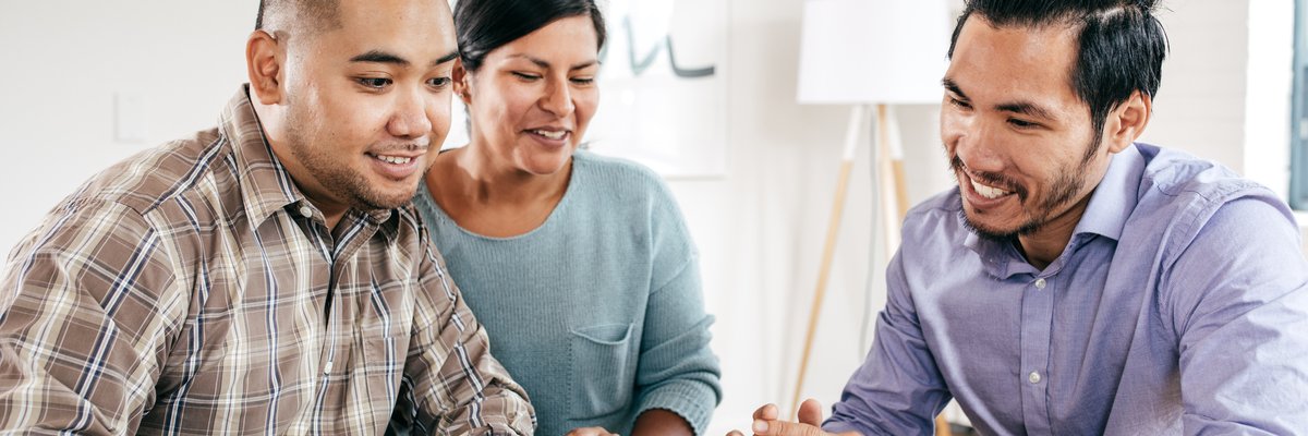 Mortgage lender goes over documents with couple.