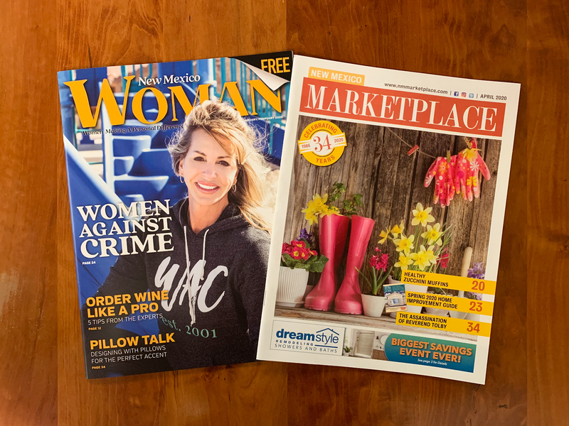 New Mexico Woman and New Mexico MarketPlace covers on a wood desk.