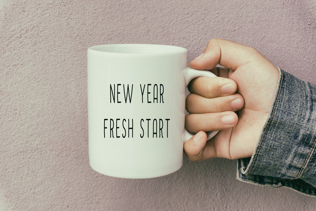 A coffee mug reading New Year Fresh Start.