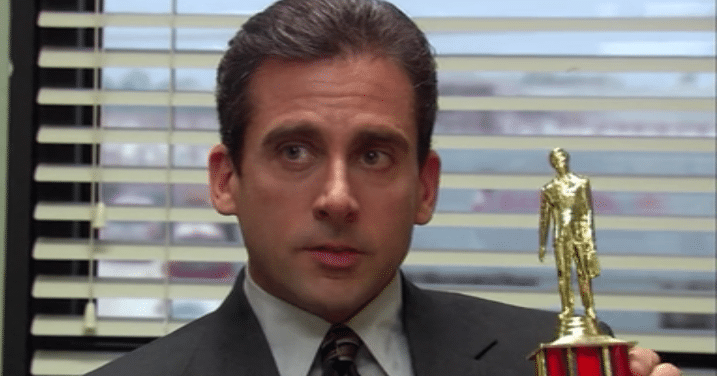 Michael Scott, a character from the TV show The Office, holding a trophy.