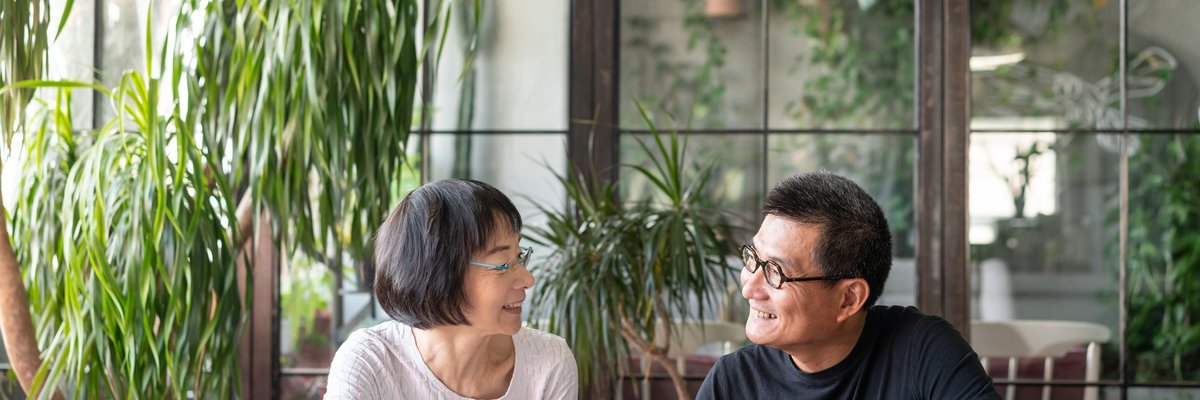 An older couple sit together and go over their investment portfolio.