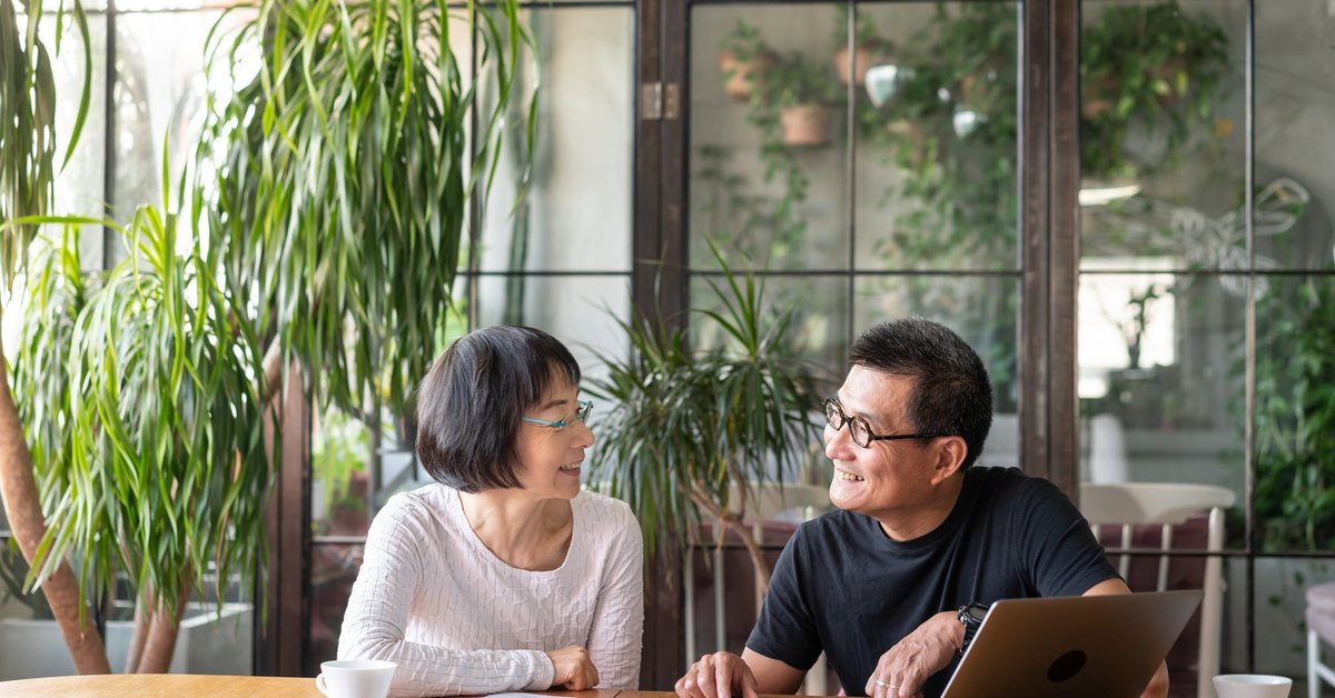 An older couple sit together and go over their investment portfolio.