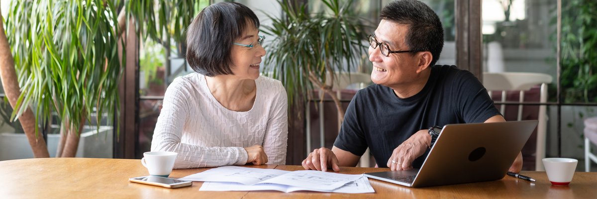 An older couple sit together and go over their investment portfolio.