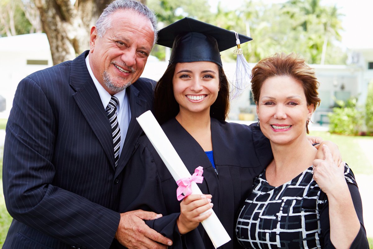 parents with college student at graduation