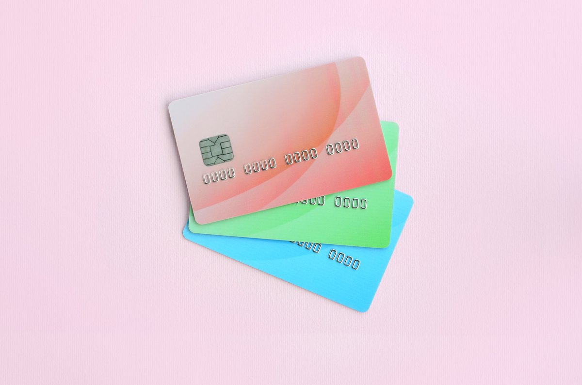 Pastel-colored credit cards on a pink background