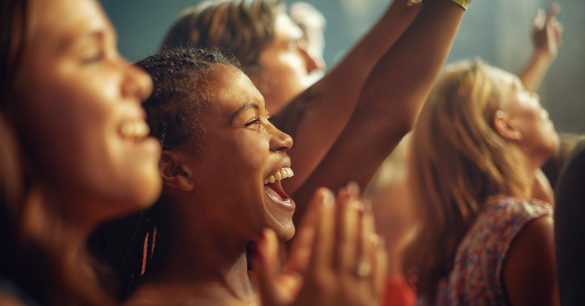 People in a crowd enjoying some form of live entertainment