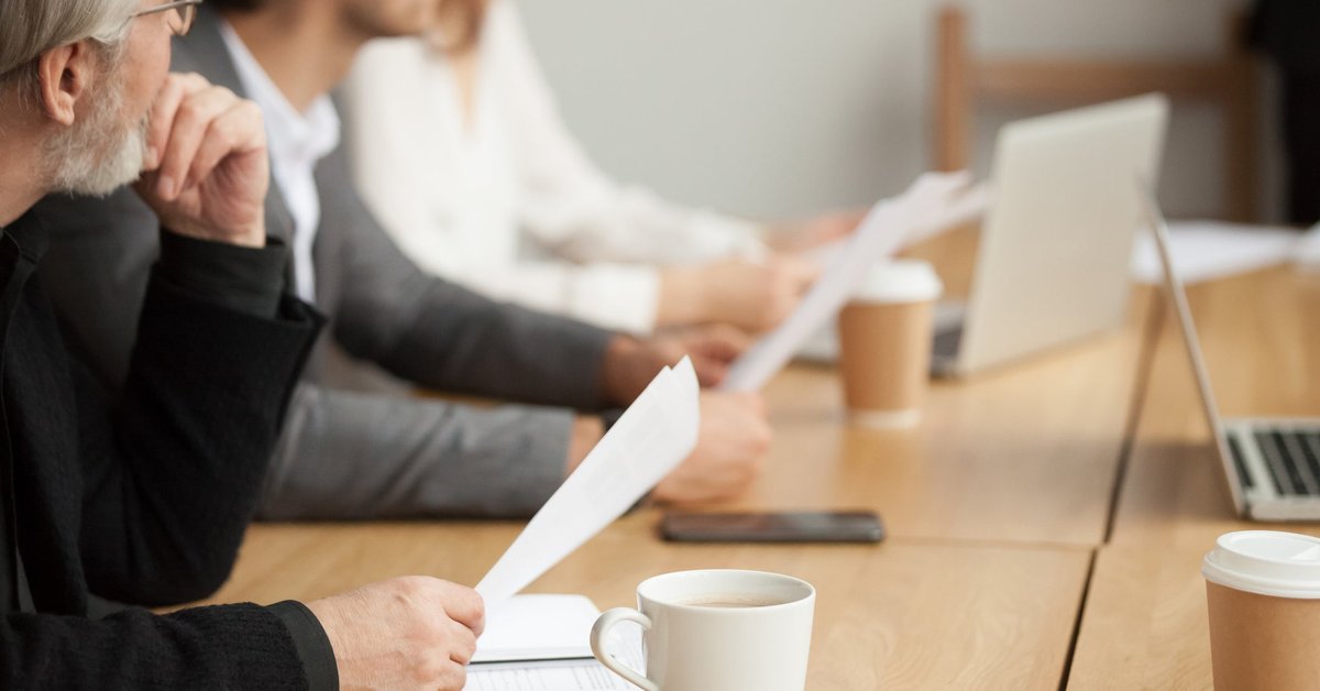 People looking towards the front during a business meeting