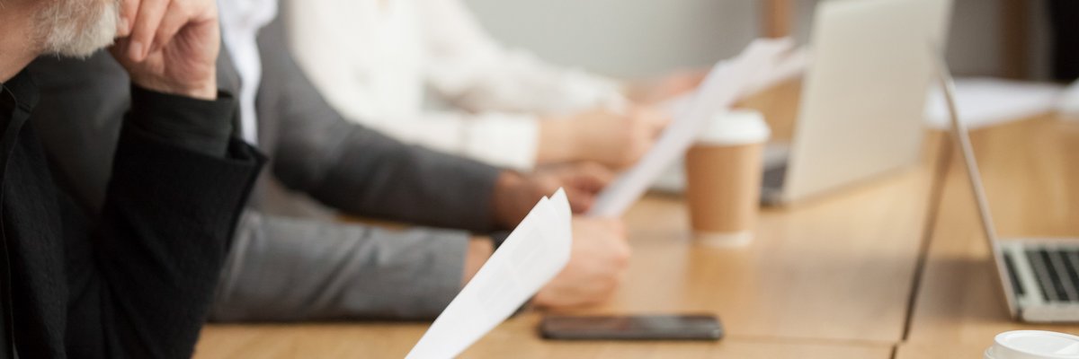 People looking towards the front during a business meeting