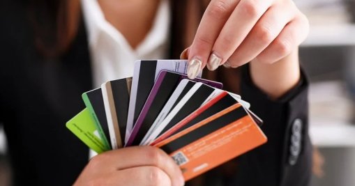 Person Holding Fan Of Credit Cards