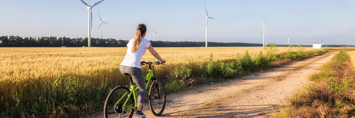 Person riding their bike through wind farm.