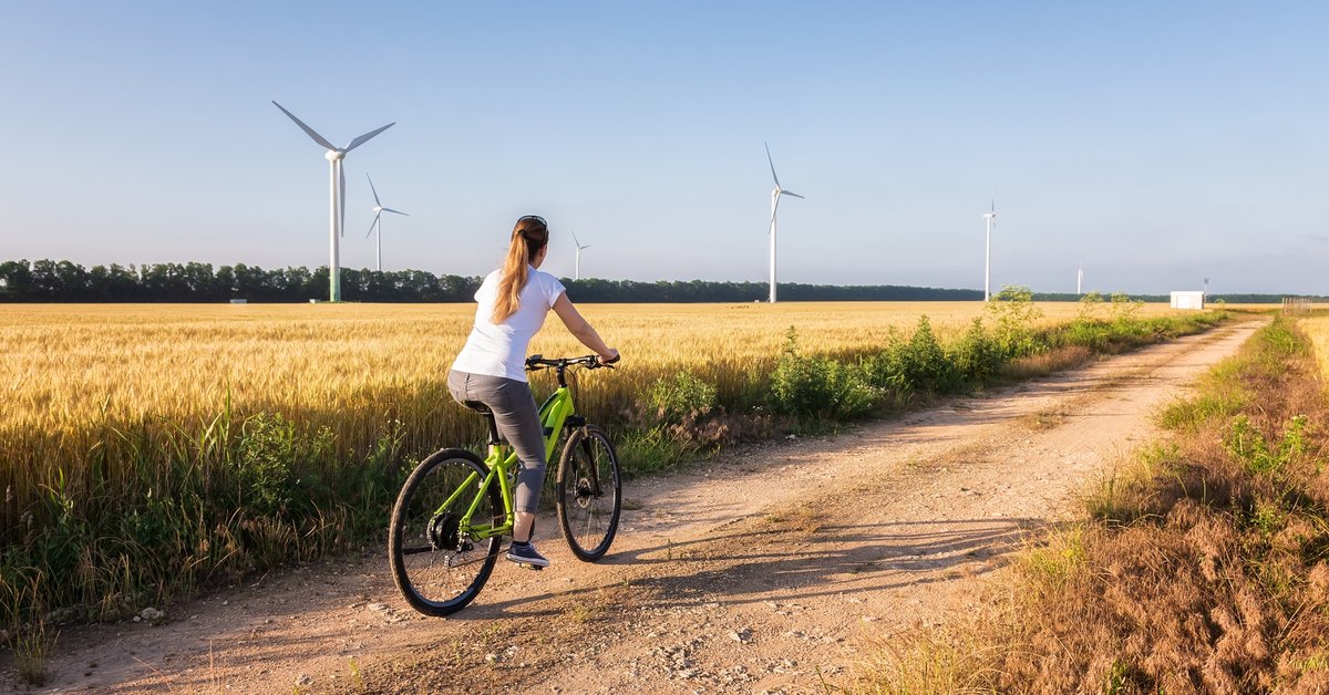Person riding their bike through wind farm.