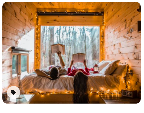 A couple reading books in a tiny cabin.