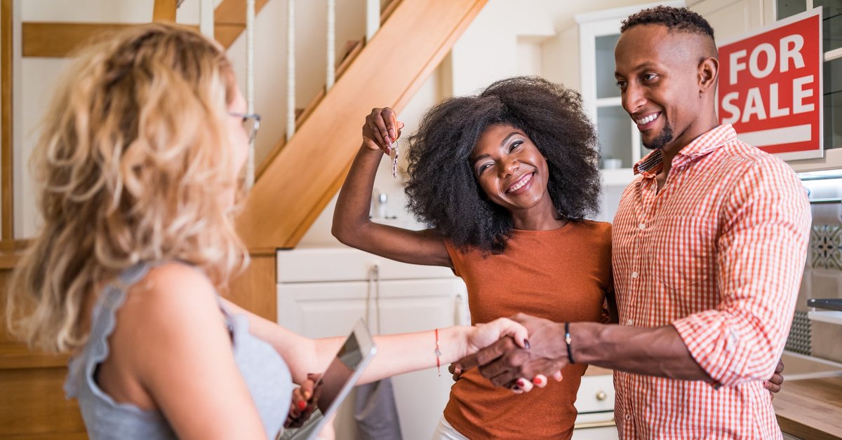 Real estate agent congratulating a new owner for buying new house