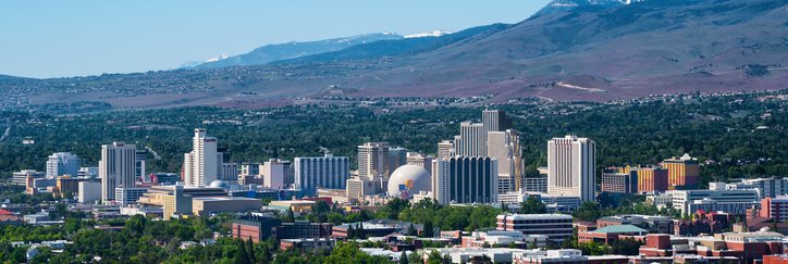 An aerial view of Reno, Nevada, with mountains in the background.