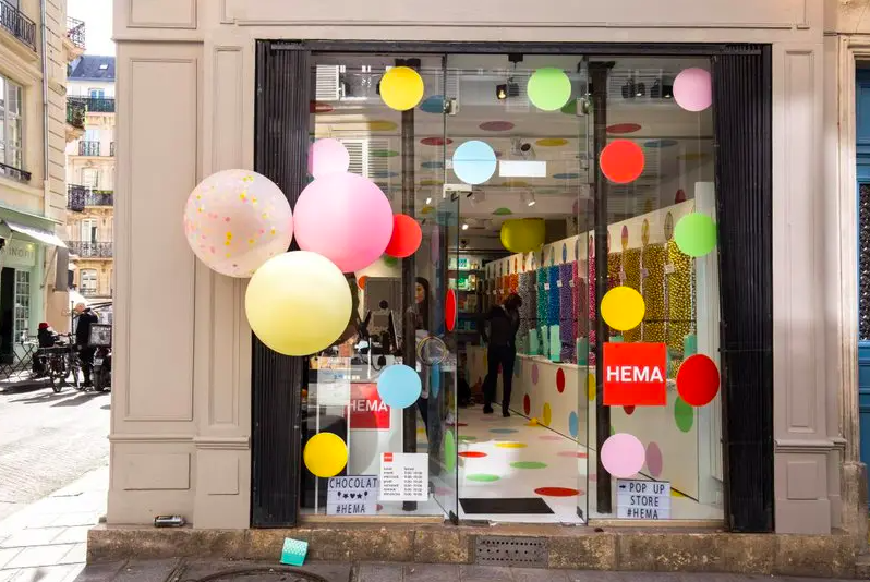 Balloons outside a HEMA display case.