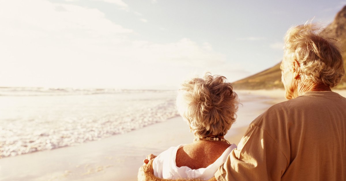 Senior couple standing on beach