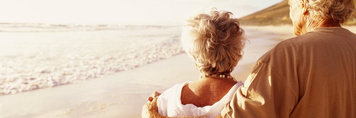 Senior couple standing on beach