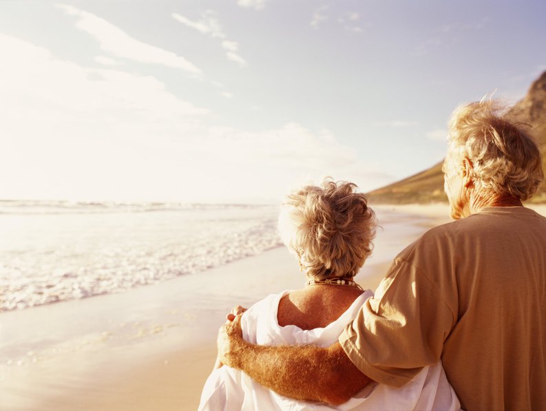 Senior couple standing on beach