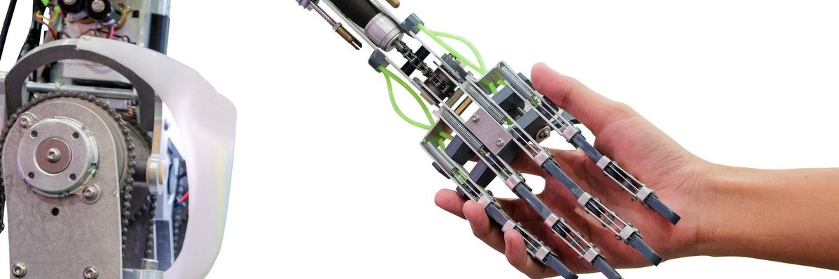 A robot holds a human hand.