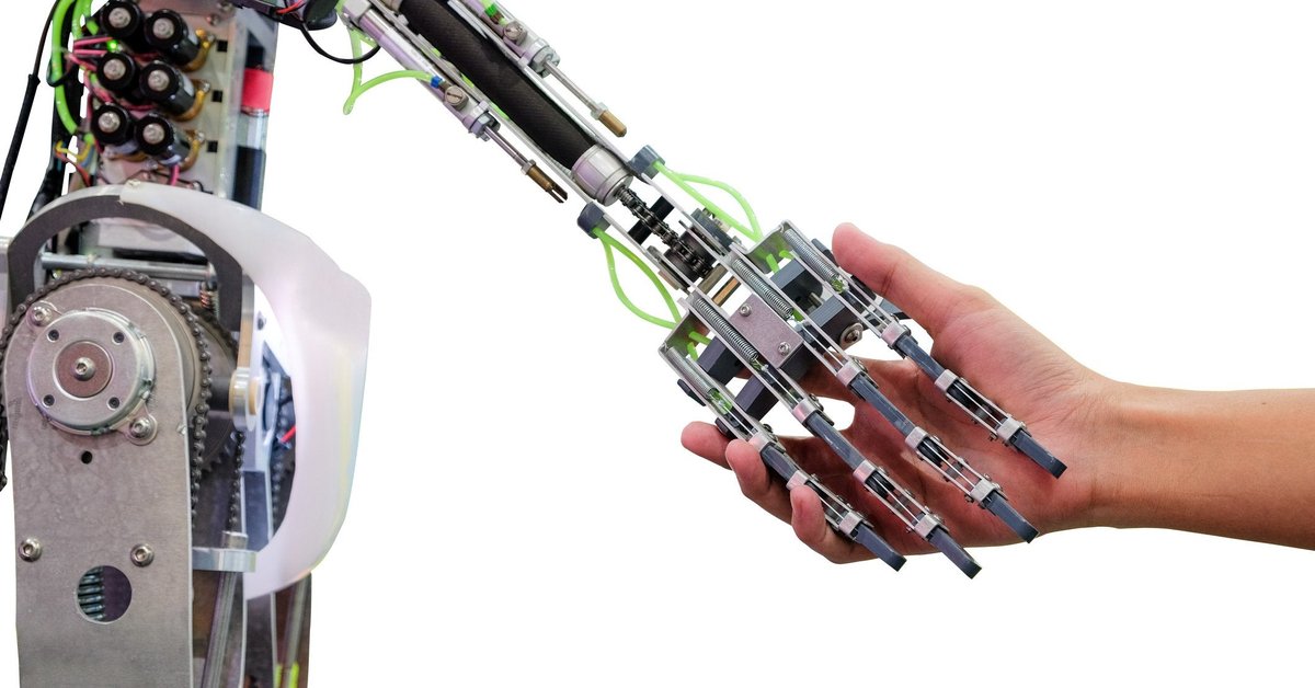 A robot holds a human hand.
