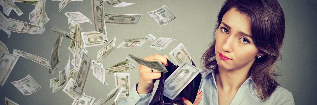 Sad woman with money flying out of wallet