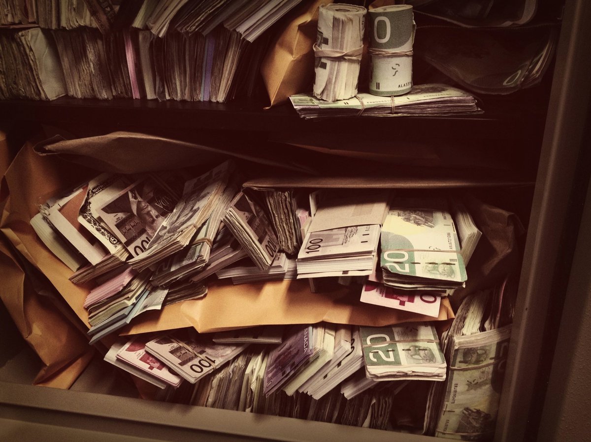 Vault filled with stacks and rolls of money.