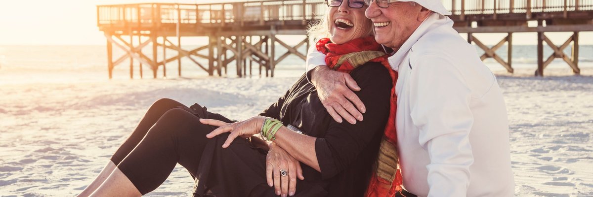 Senior couple embracing on the beach.
