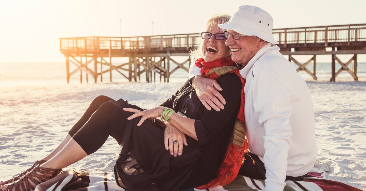 Senior couple embracing on the beach.
