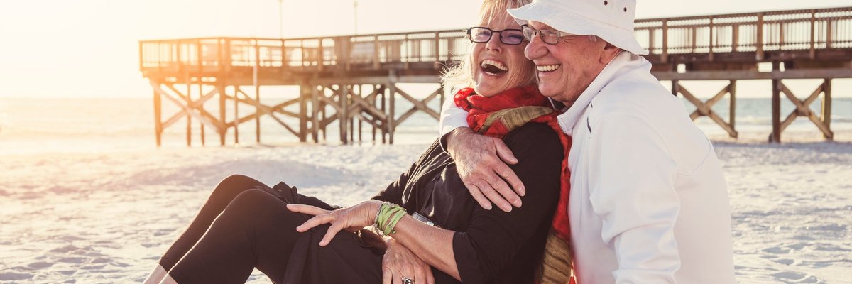 Senior couple embracing on the beach.