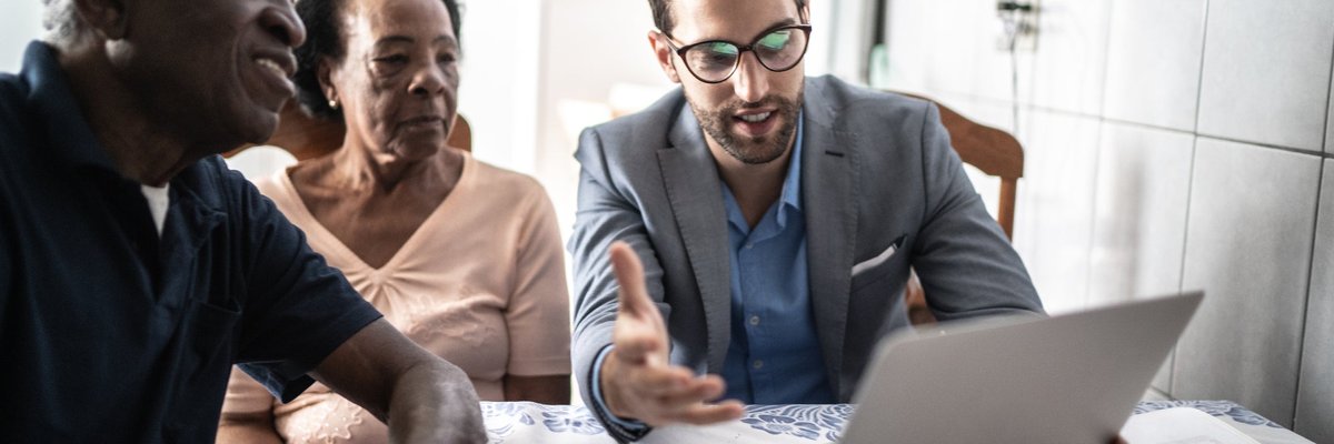 Senior couple meets with male professional.