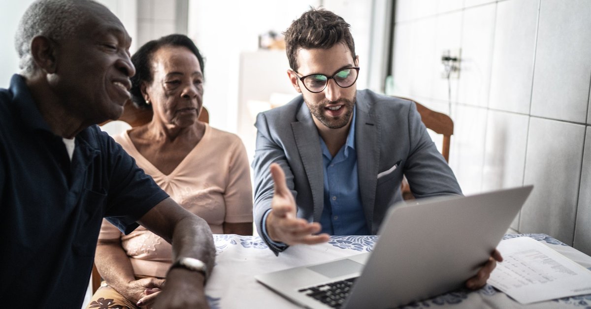 Senior couple meets with male professional.