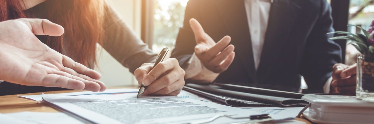 Two people signing a document.