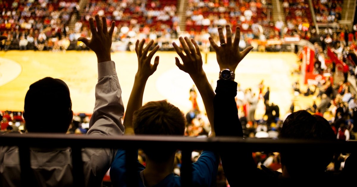 Spectators inside a basketball arena.