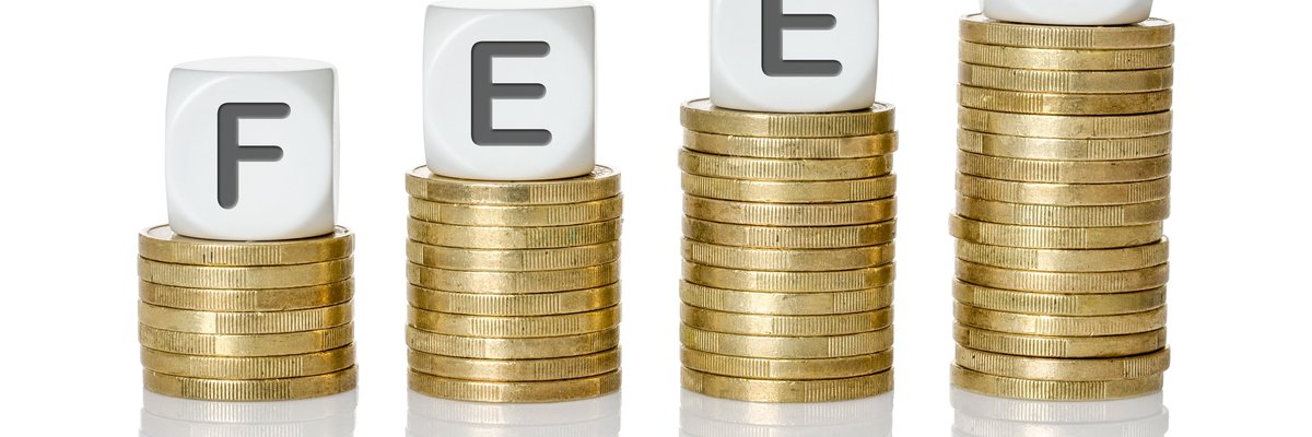 Stacks of coins in increasing size with blocks spelling the word FEES atop the piles.