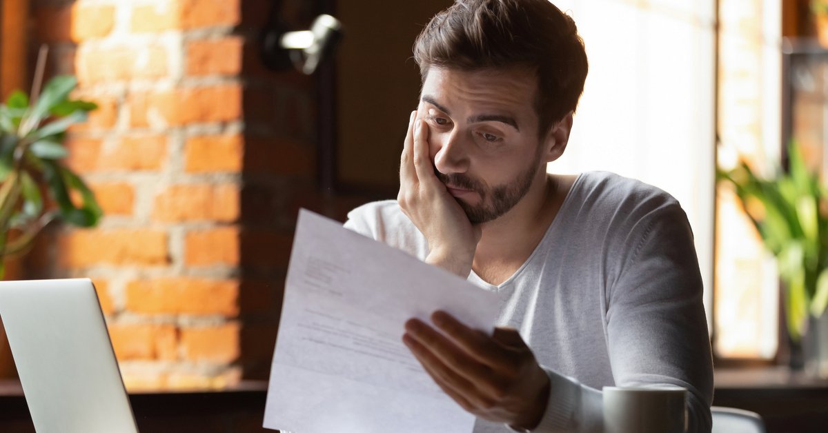 Stressed Out Guy Looking At Paper