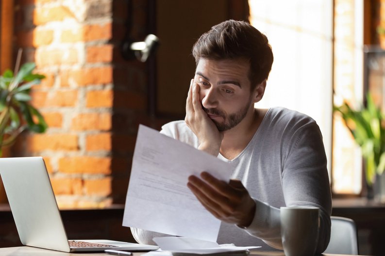Stressed Out Guy Looking At Paper
