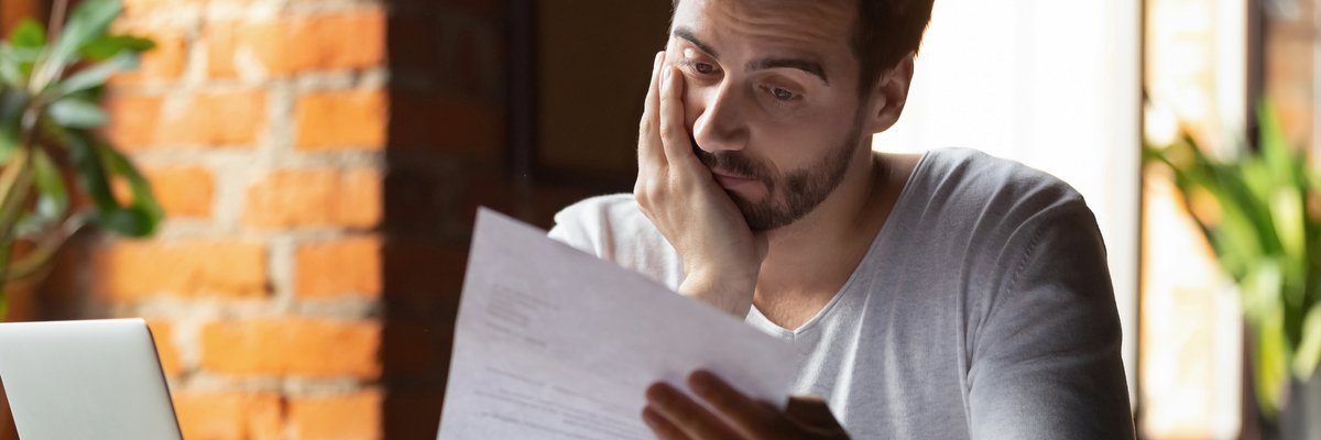Stressed Out Guy Looking At Paper