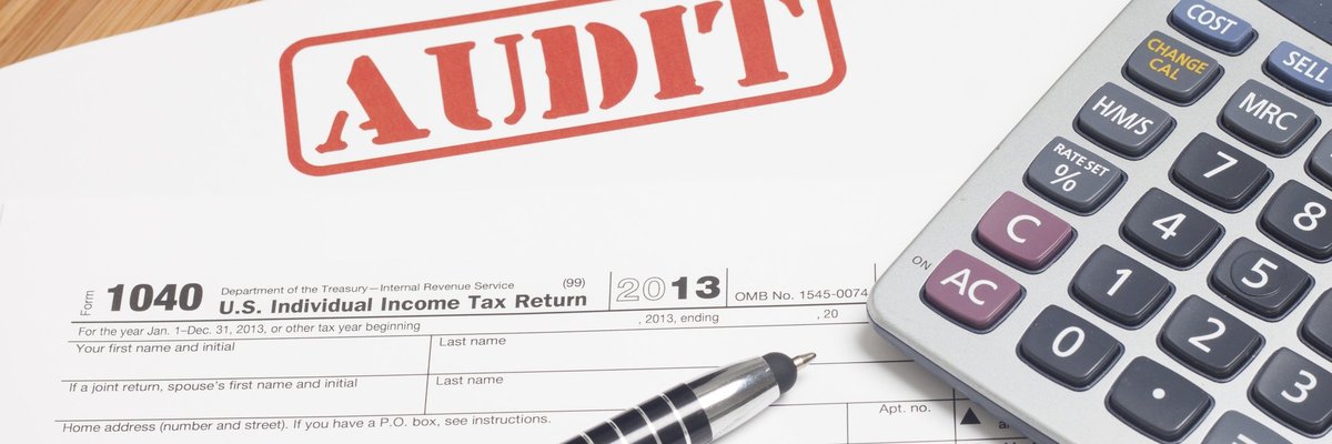 A 1040 tax form with a red AUDIT stamp across the top.