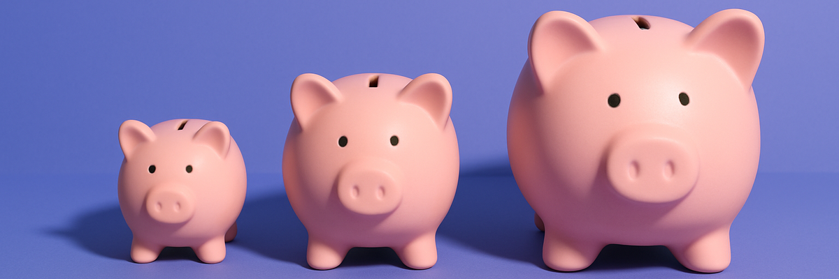 Three piggy banks of increasing size on a purple background