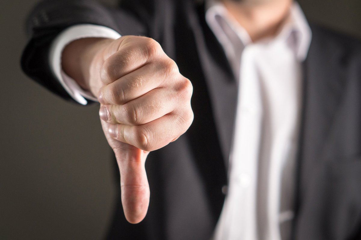 Man holding his hand out giving thumbs down
